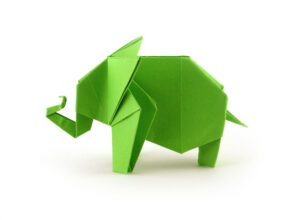 Green origami elephant on a white background