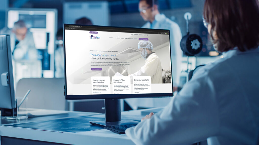 Chemists and scientists reviewing website on a computer in a laboratory